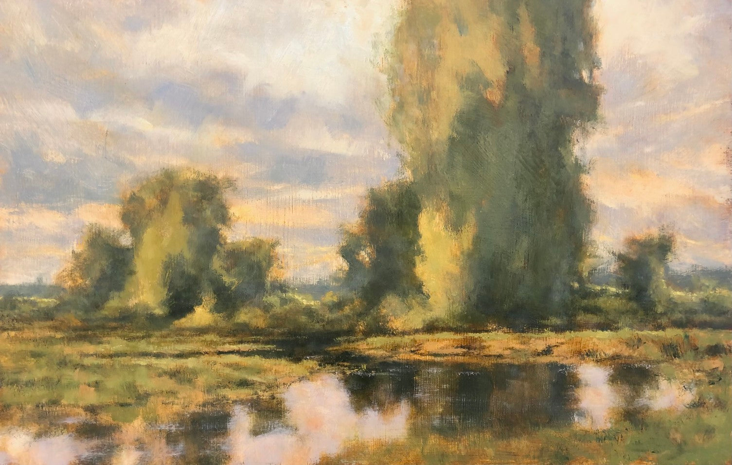 Landscape painting by artist Clint Bova. Landscape focuses on two stands of sycamore trees with a still body of water in front of them. The colors are greens, yellows, and blues. Style is classic, barbizon school 
